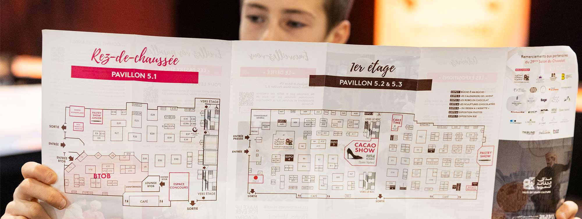 Someone looking at the fold-out map of the Salon.