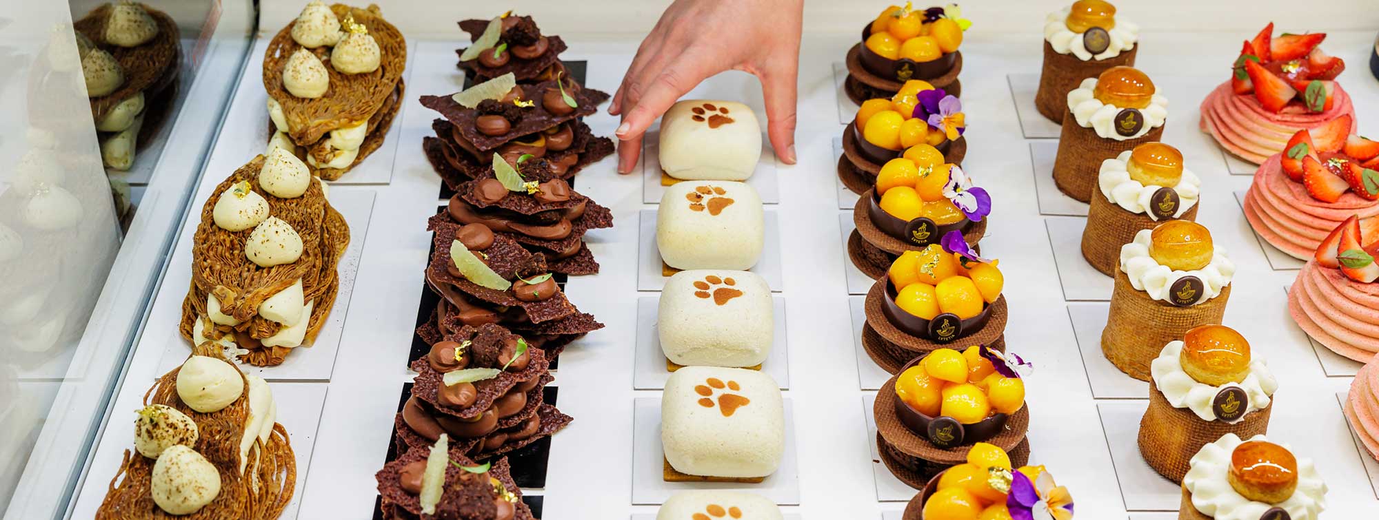 Display case filled with pastries in the Cake Time area.