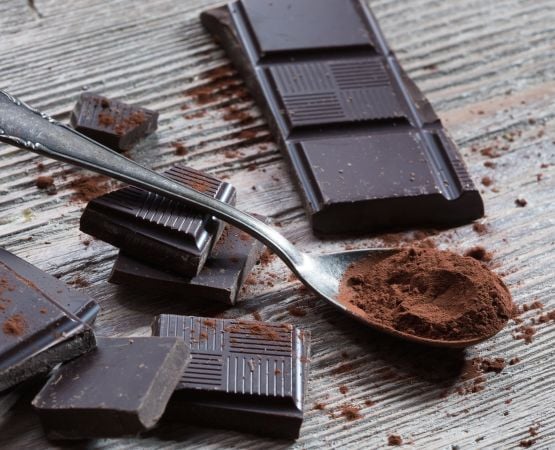 Chocolate squares scattered with a spoon.