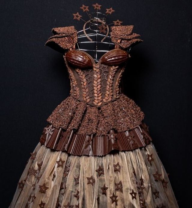 Focus on a chocolate dress on display.