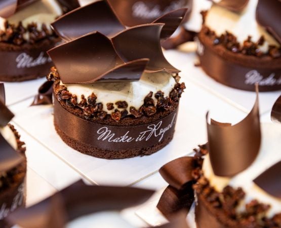 Chocolate cake decorated with chocolate and a ribbon
