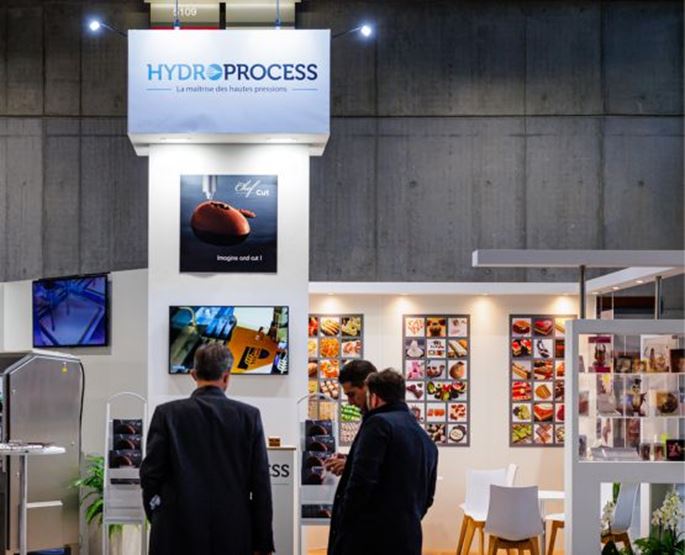 Exhibitor at the BtoB Village at his booth with a visitor.